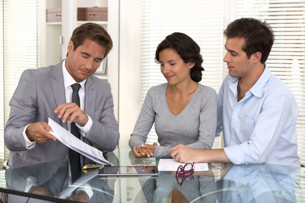 couple reviewing paperwork with an attorney