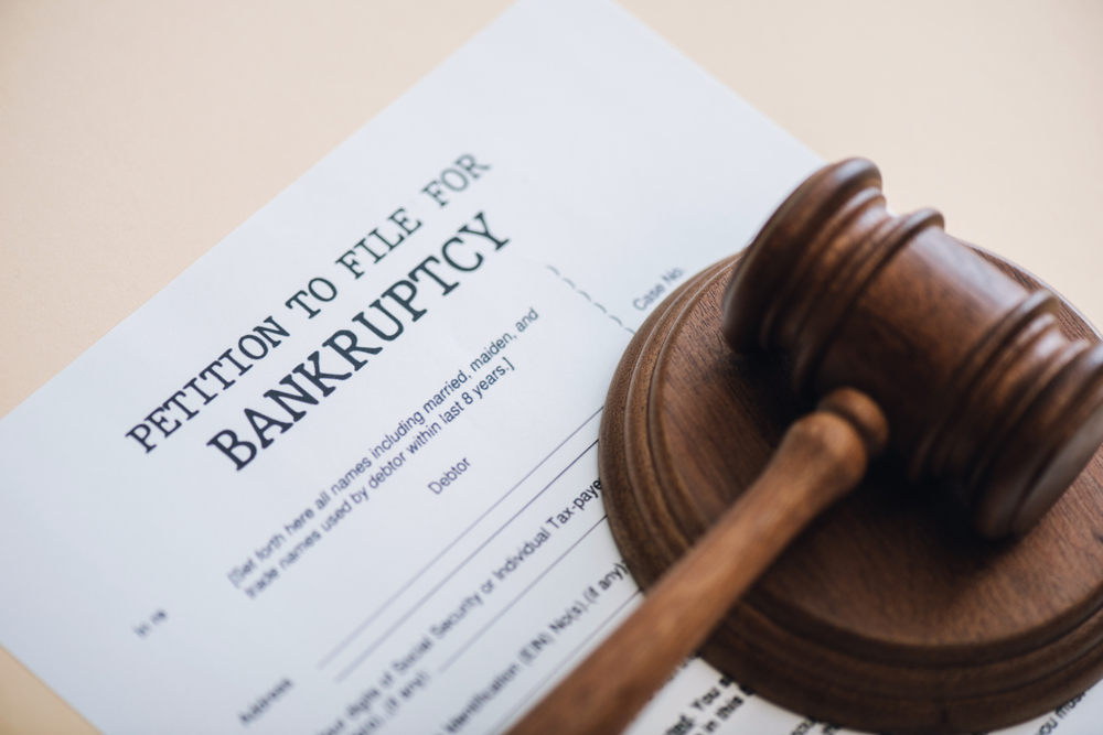 Gavel on top of a piece of paper that says petition to file for bankruptcy