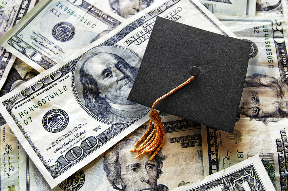 Graduation cap on top of paper money